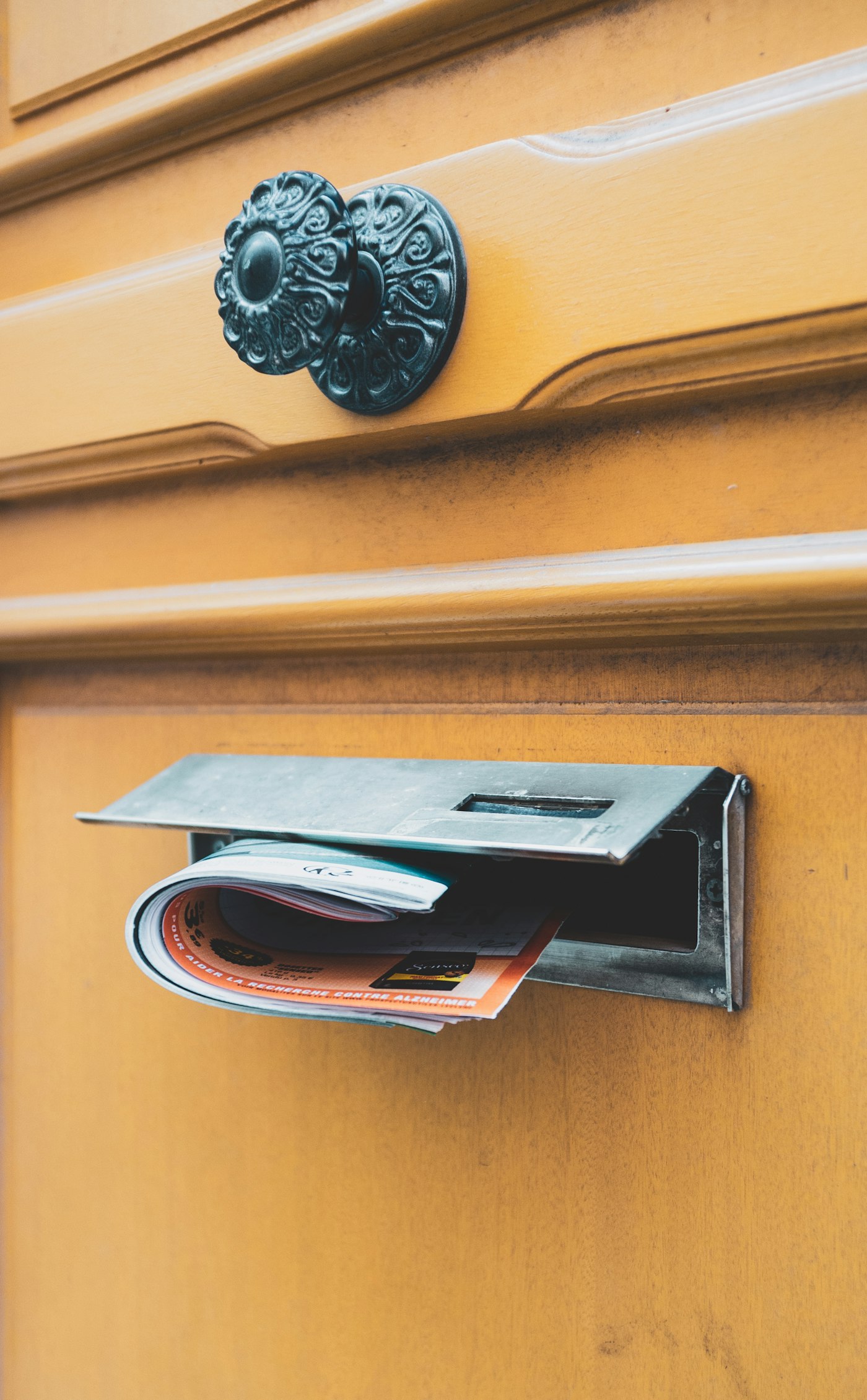 A leaflet being delivered through a front door letterbox